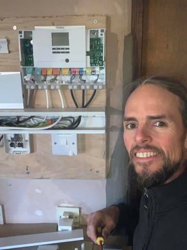 Adam working on a heat pump control panel